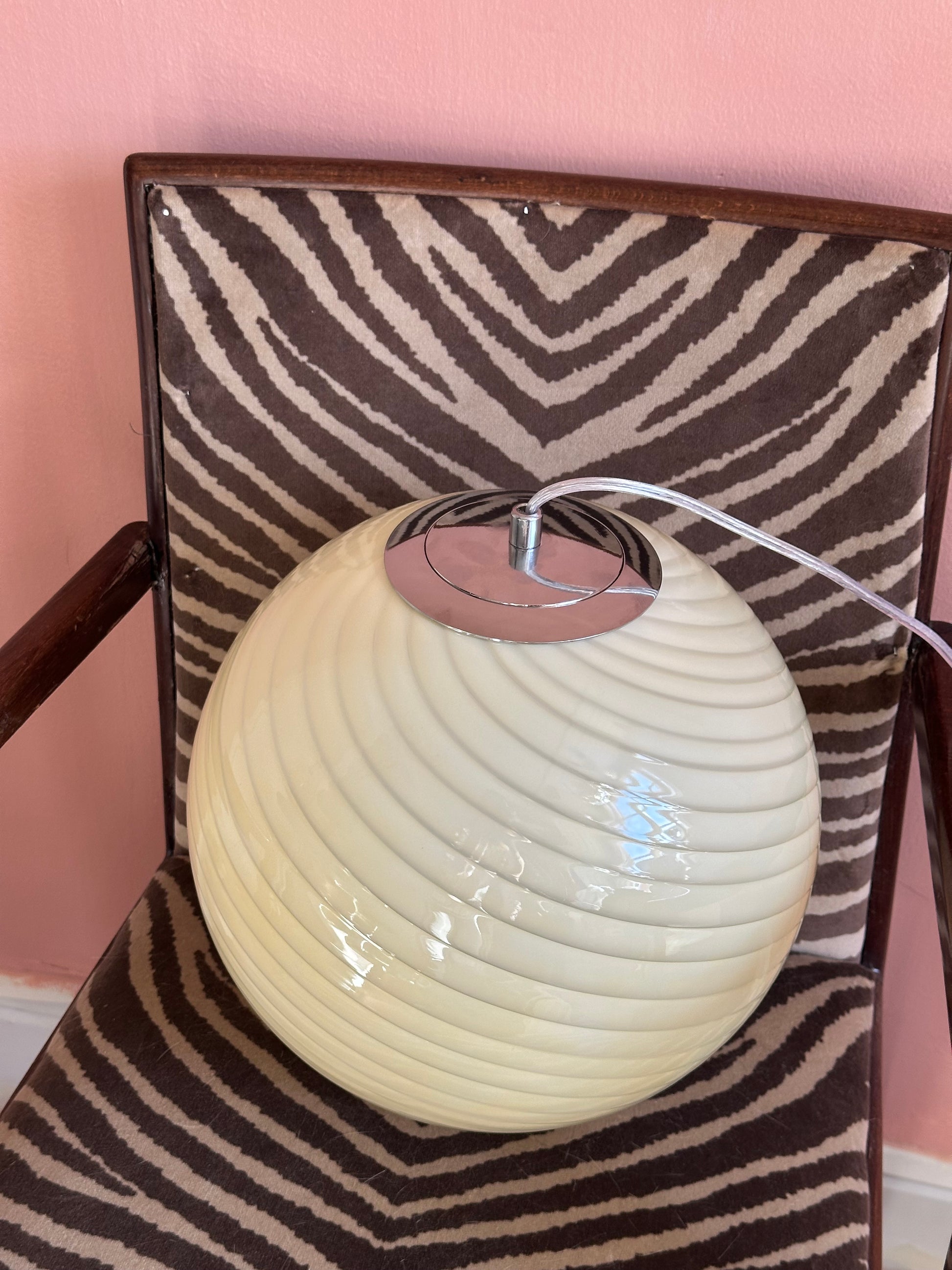 Murano style cream swirl glass globe pendant with chrome silver top hardware detail close up