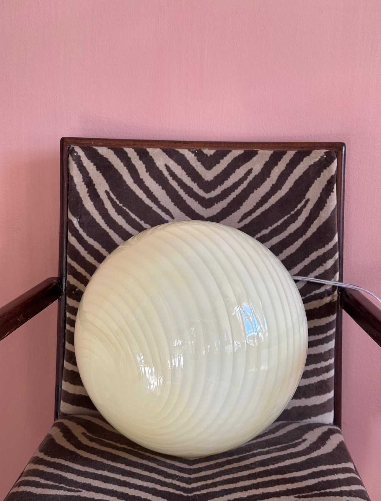 Vintage retro murano style cream swirl glass globe pendant lamp, round art glass shade close up unlit